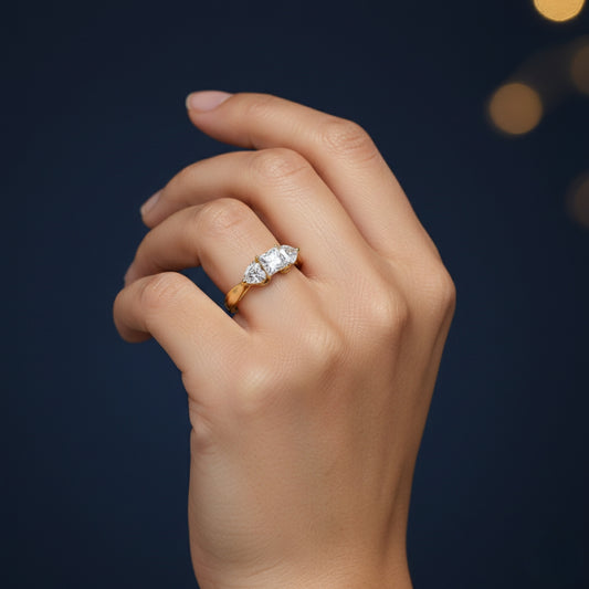 Hand wearing a Moissanite diamond ring against a dark background