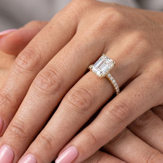 Rose gold ring with a moissanite diamond on a hand