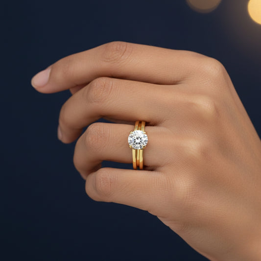 Hand wearing a 1ct moissanite gold ring with a diamond on a dark background