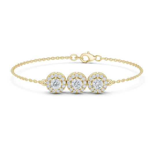 Gold bracelet with three moissanite diamond-like stones on a white background