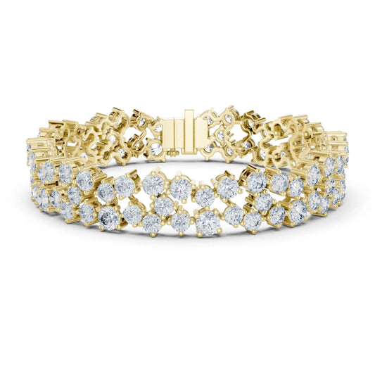 A yellow gold tennis bracelet featuring multiple rows of round-cut clear moissanite gemstones, displayed on a clean white background.