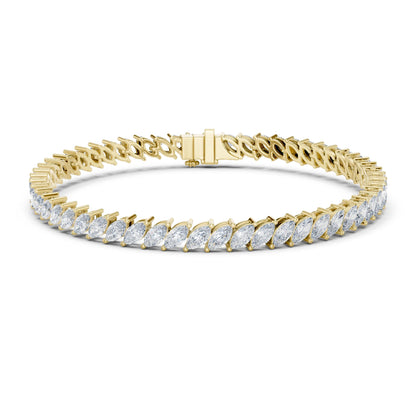 Gold bracelet with clear moissanite gemstones on a white background