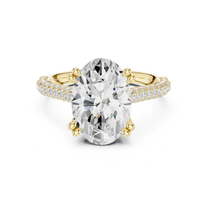 Gold and moissanite diamond ring with a large central gemstone on a white background