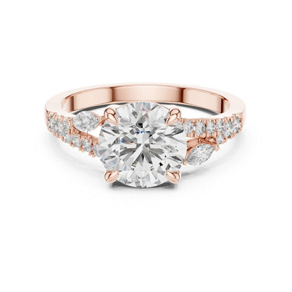 Rose gold ring with a large moissanite diamond and smaller diamonds on the band against a white background