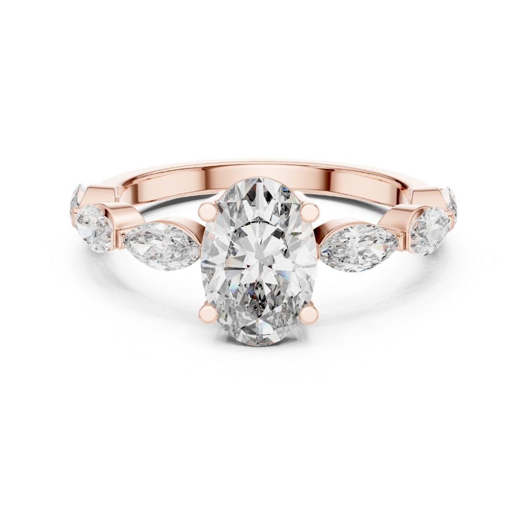 Rose gold ring with a large moissanite diamond and smaller pear-shaped diamonds on a white background