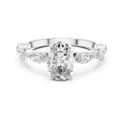 Diamond ring with a central oval-cut moissanite diamond and pear-shaped side stones on a white background