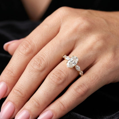 Close-up of a hand wearing a moissanite diamond ring with a dark background