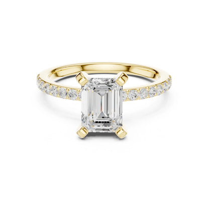 Gold ring with emerald-cut moissanite diamond and smaller diamonds on a white background