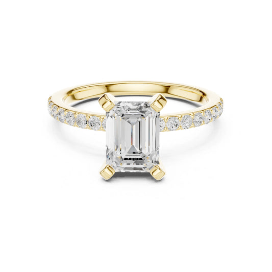 Gold ring with emerald-cut moissanite diamond and smaller diamonds on a white background