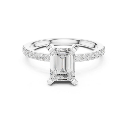 moissanite Diamond ring with a central emerald-cut diamond and smaller diamonds on the band against a white background