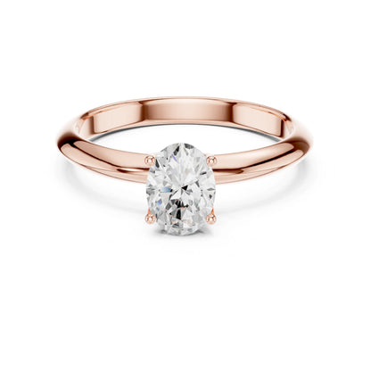Rose gold ring with a moissanite diamond on a white background