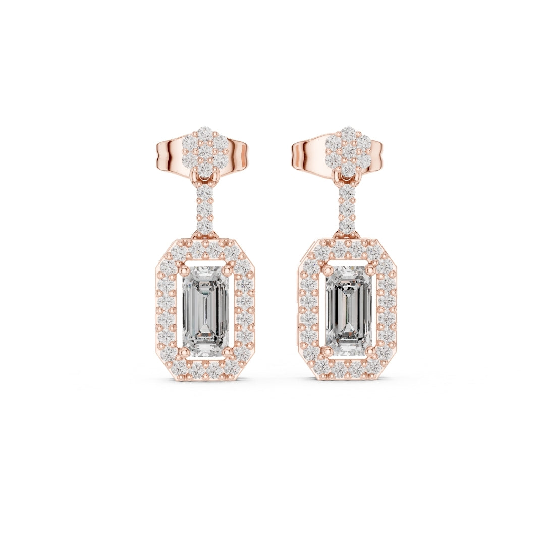 Rose gold earrings with emerald-cut moissanite gemstones on a white background