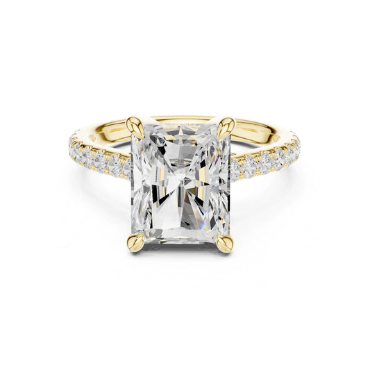 Gold ring with a large moissanite diamond and smaller diamonds on the band against a white background