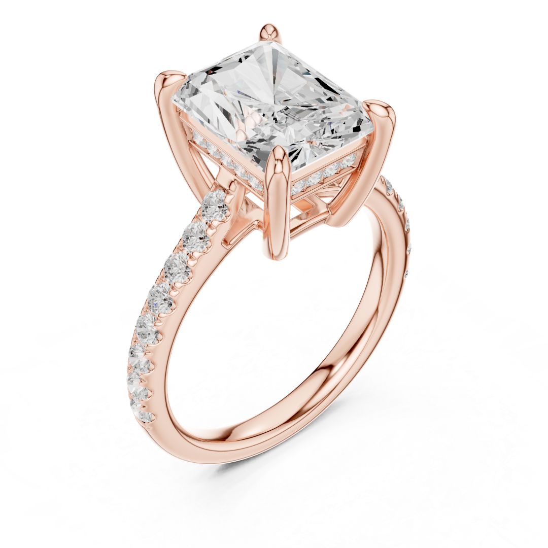 Rose gold ring with a large moissanite diamond and smaller diamonds on the band against a white background