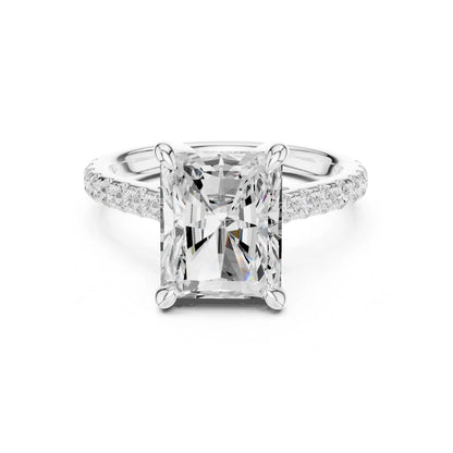 moissanite Diamond ring with a large central gemstone and smaller stones on the band against a white background