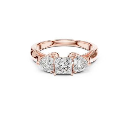 Rose gold ring with three Moissanite diamonds on a white background