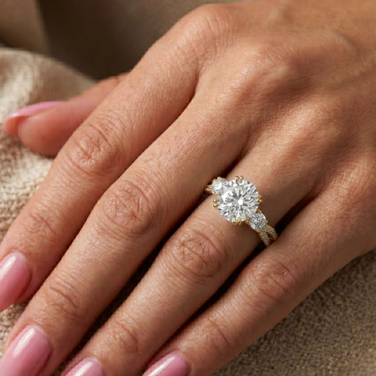 Close-up of a hand wearing a moissanite diamond ring on a neutral background
