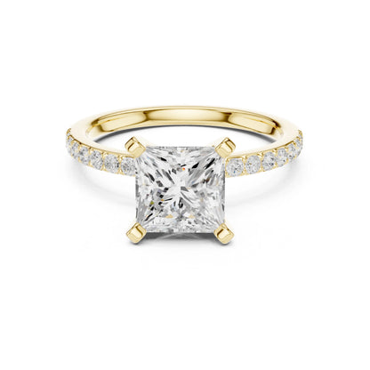 Gold ring with a large moissanite diamond and smaller diamonds on the band against a white background