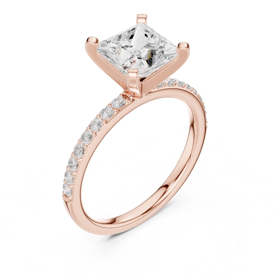 Rose gold ring with a large moissanite  diamond and smaller diamonds on the band against a white background