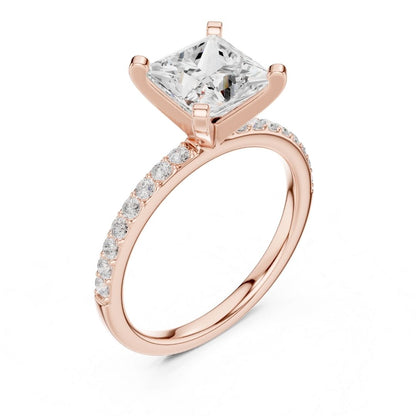 Rose gold ring with a large moissanite  diamond and smaller diamonds on the band against a white background