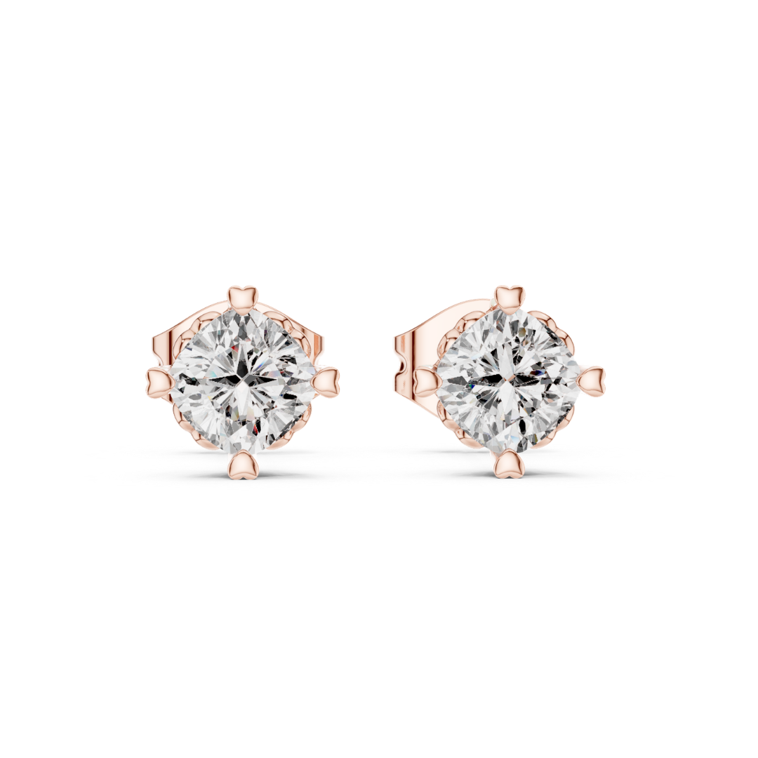 Rose gold stud earrings with clear moissanite gemstones on a white background