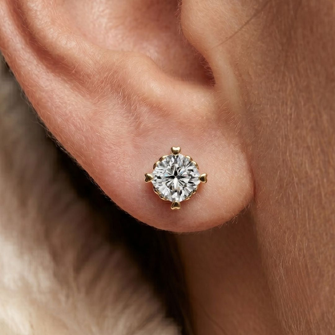 Gold earring with a moissanite diamond on an ear