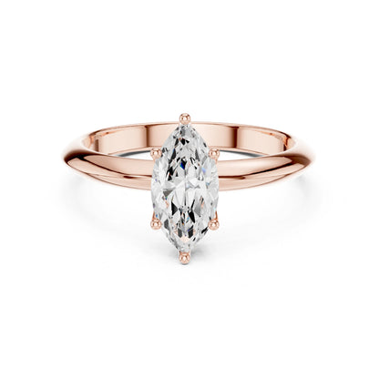 Rose gold ring with a pear-shaped moissanite diamond on a white background