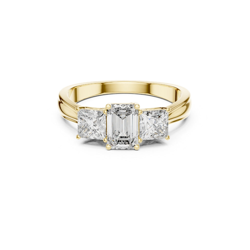 Gold ring with emerald-cut moissanite diamonds on a white background