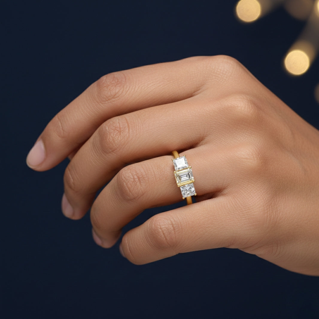 Gold ring with a Moissanite diamond on a hand against a dark background