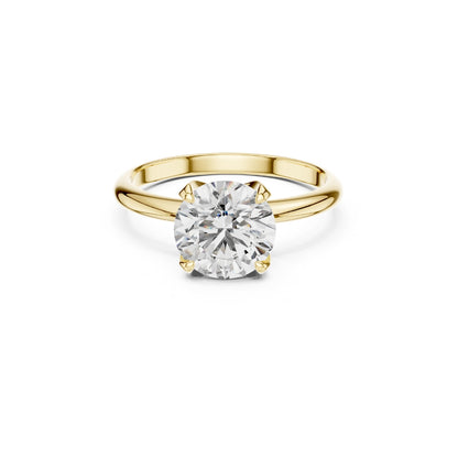 Gold ring with a 1ct Moissanite diamond on a white background