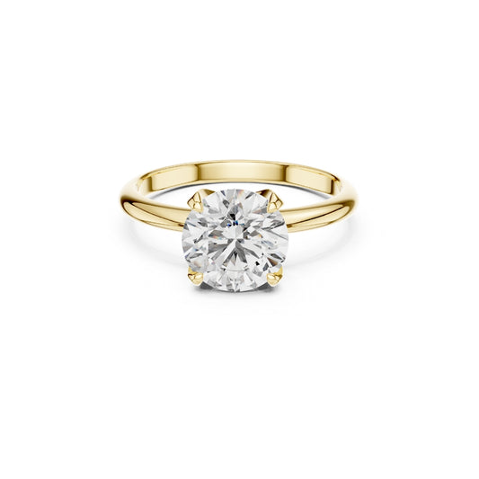 Gold ring with a 1ct Moissanite diamond on a white background