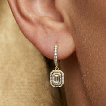 moissanite Diamond earring worn on an ear with a neutral background