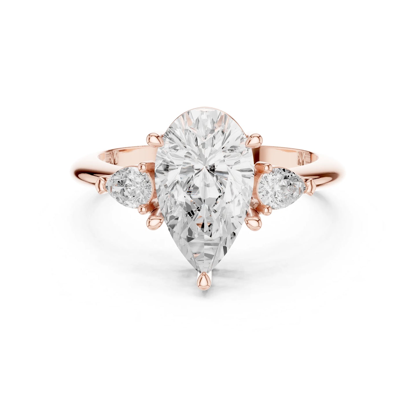 Rose gold ring with a large pear-shaped moissanite diamond and smaller side diamonds on a white background