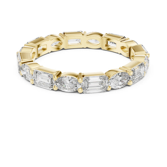 Gold ring with emerald-cut moissanite diamonds on a white background
