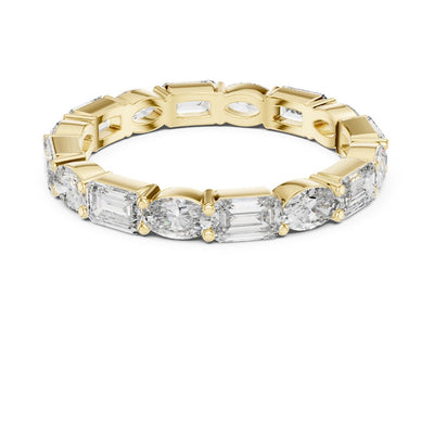 Gold ring with emerald-cut moissanite diamonds on a white background