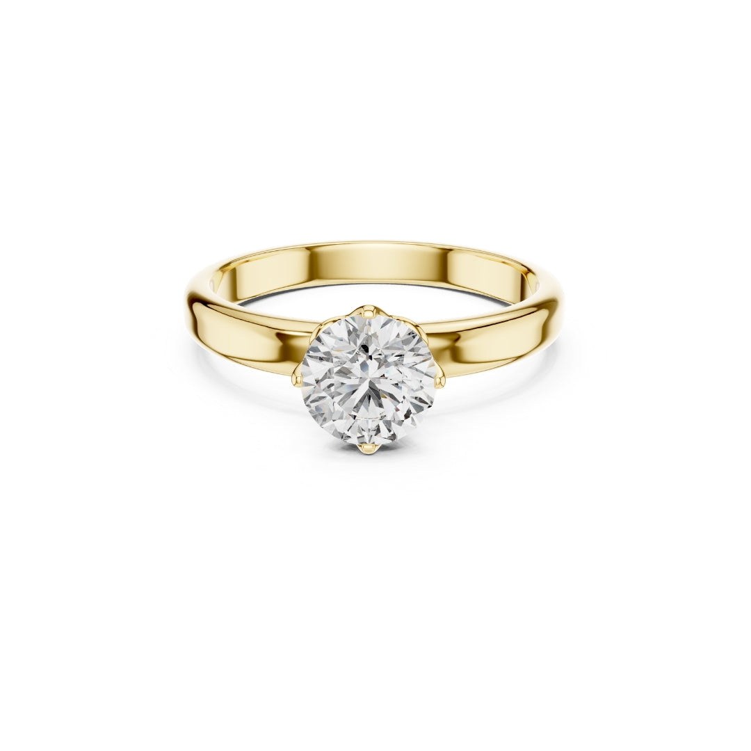 Gold ring with a 1ct moissanite diamond on a white background