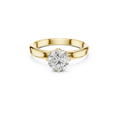 Gold ring with a 1ct moissanite diamond on a white background