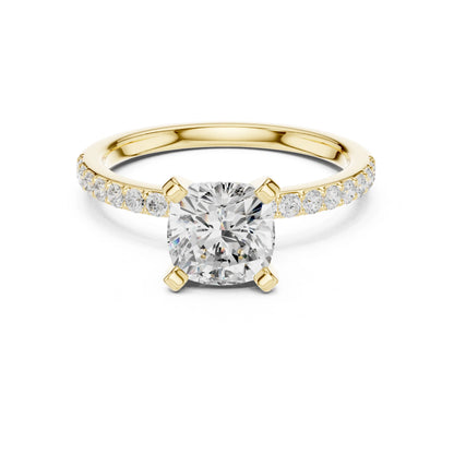 Gold ring with a large moissanite diamond and smaller diamonds on the band against a white background