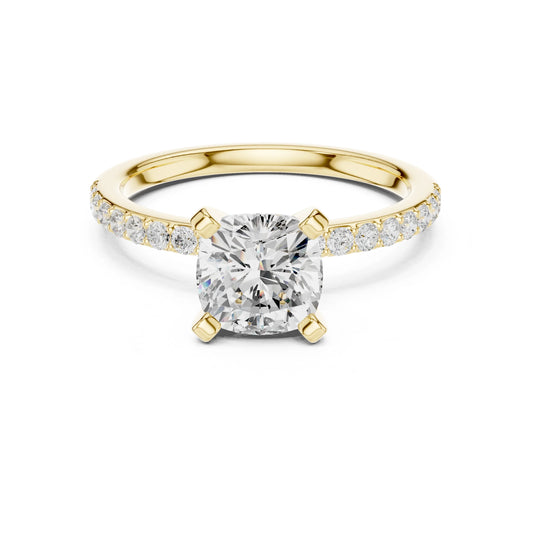 Gold ring with a large moissanite diamond and smaller diamonds on the band against a white background