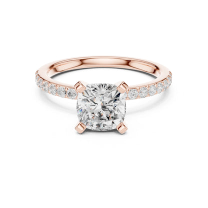 Rose gold ring with a large moissanite diamond and smaller diamonds on the band against a white background