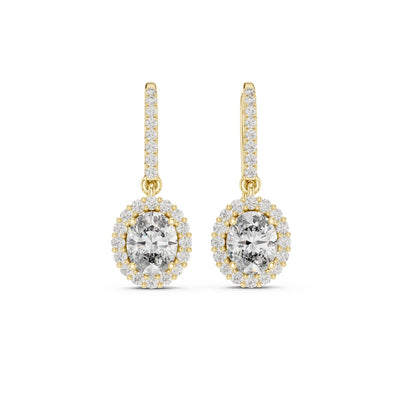 Gold earrings with clear moissanite gemstones on a white background