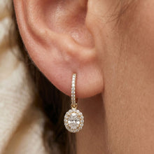 Load image into Gallery viewer, Close-up of a moissanite diamond earring on an ear with a blurred background