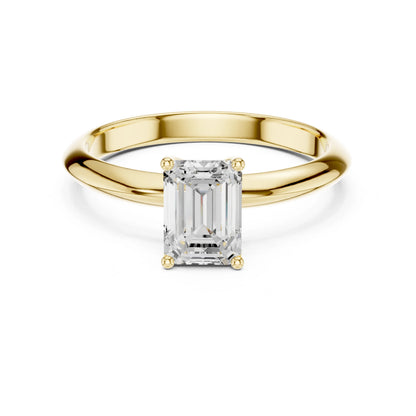 Gold ring with a rectangular moissanite diamond on a white background