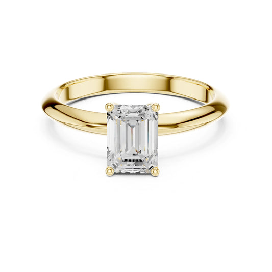 Gold ring with a rectangular moissanite diamond on a white background