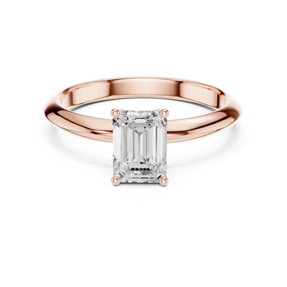 Rose gold ring with a rectangular moissanite diamond on a white background