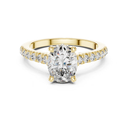 Gold ring with a large moissanite  diamond and smaller diamonds on the band against a white background