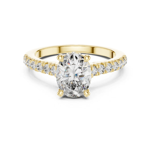 Gold ring with a large moissanite  diamond and smaller diamonds on the band against a white background