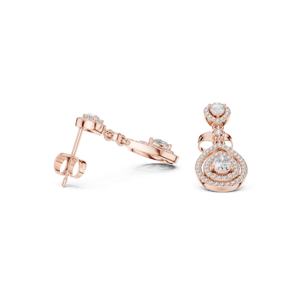 Rose gold earrings with clear moissanite gemstones on a white background