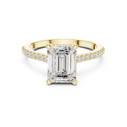 Gold ring with a large moissanite diamond and smaller diamonds on the band against a white background