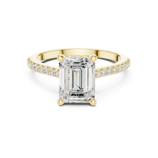 Gold ring with a large moissanite diamond and smaller diamonds on the band against a white background